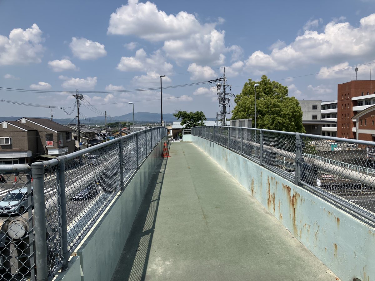 At the top of the overpass, continuing straight west