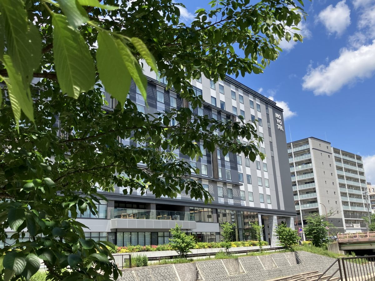 The Novotel Nara hotel seen from the same vantage point in early May, surrounded by green trees