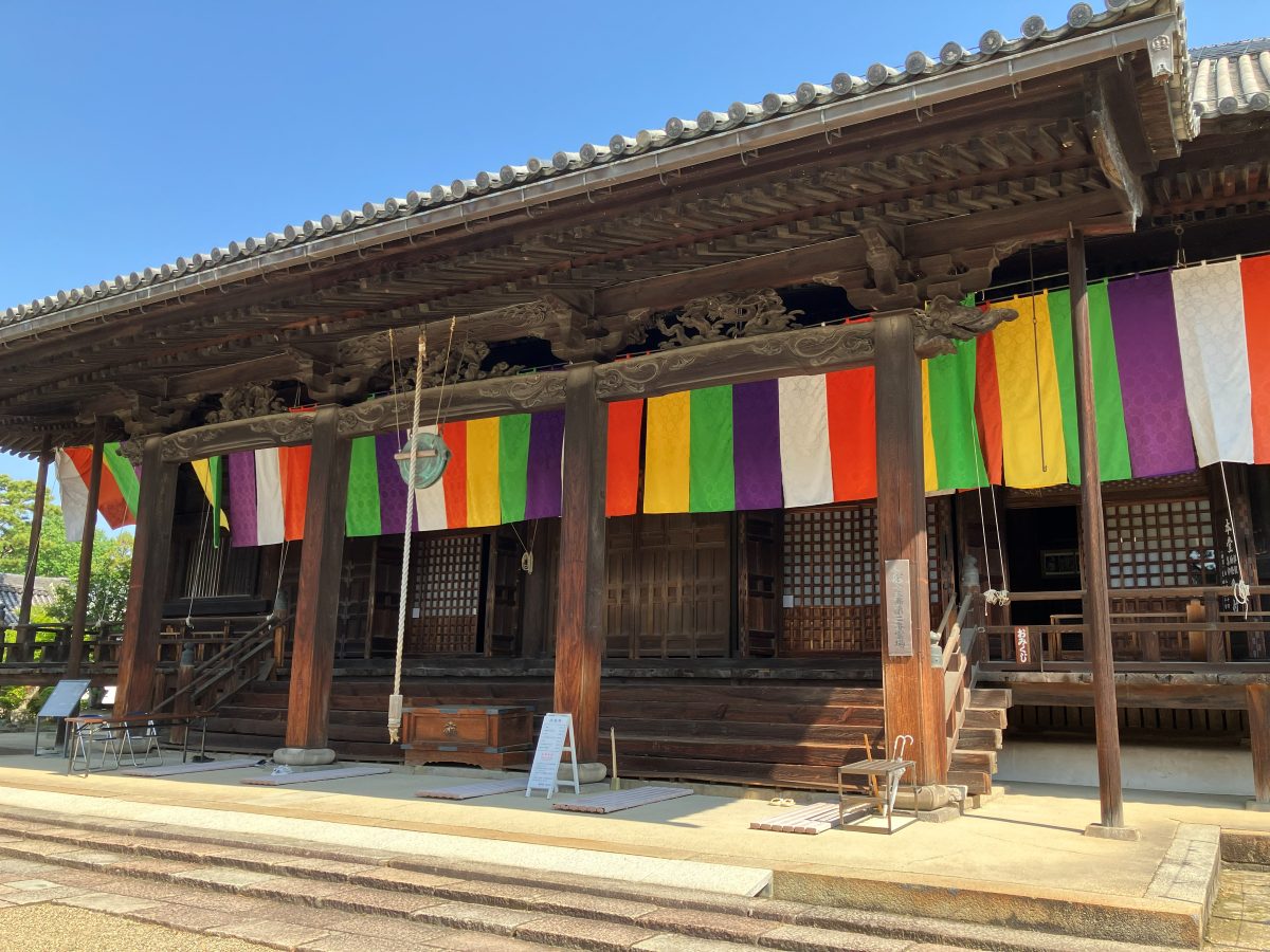 Main Hall of Saidaiji — a large wooden hall with five-colored curtains hanging under its eaves